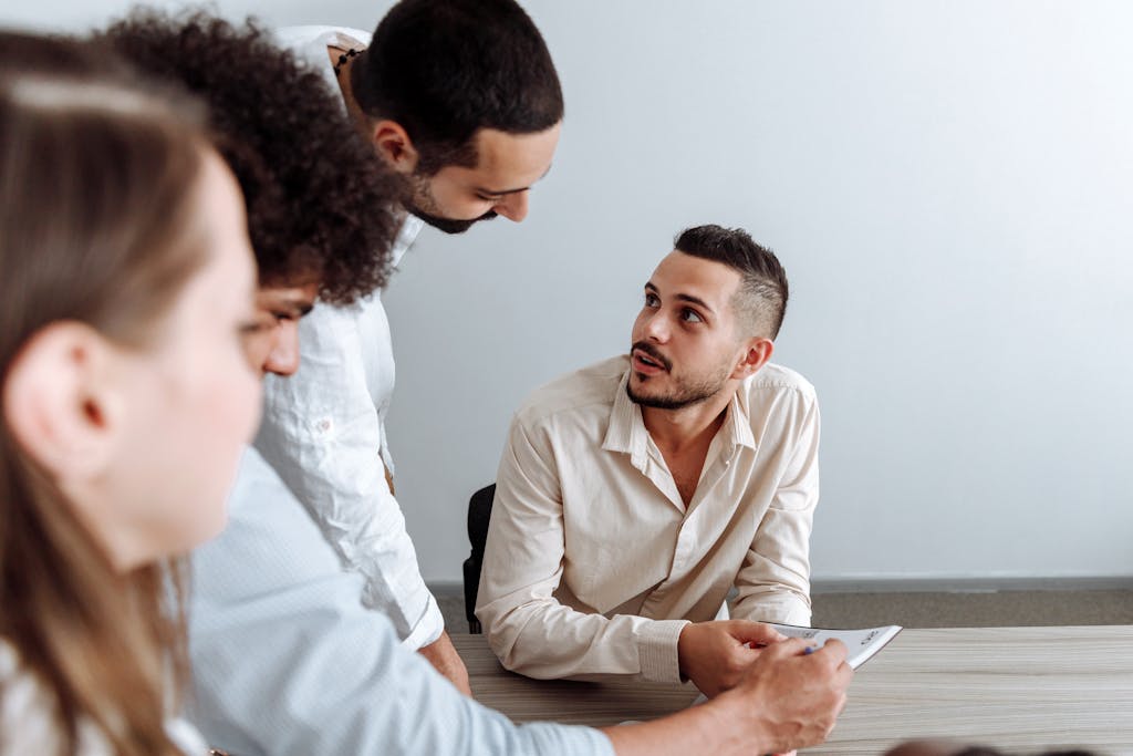Diverse professionals collaborating and discussing ideas in a business meeting environment.